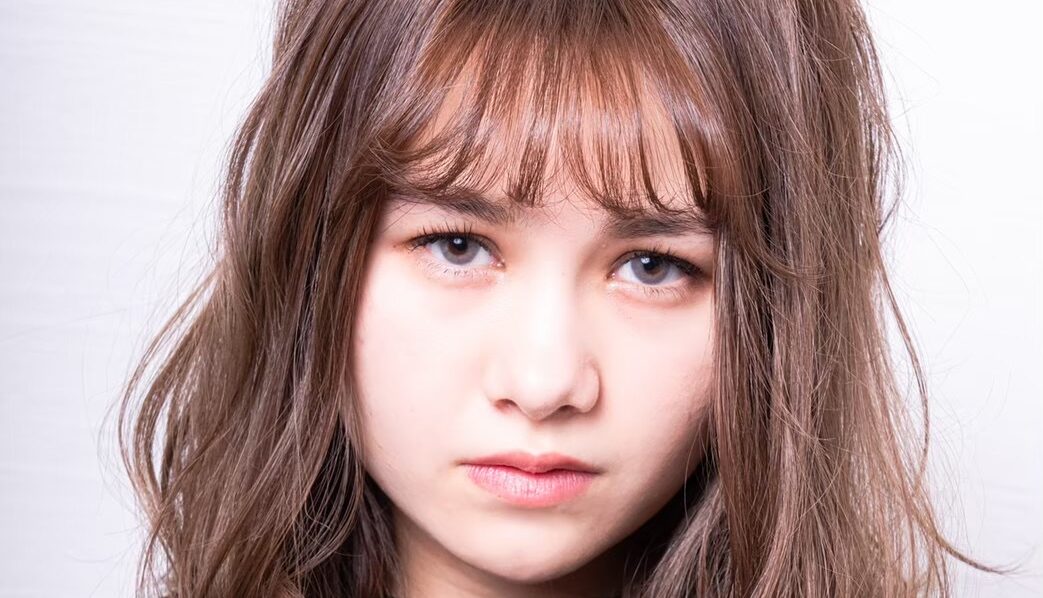 Woman with hair curlers holding a teacup