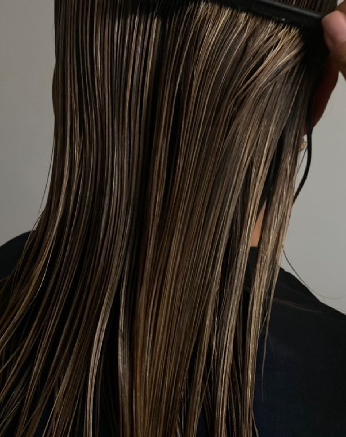 Long brown hair being styled