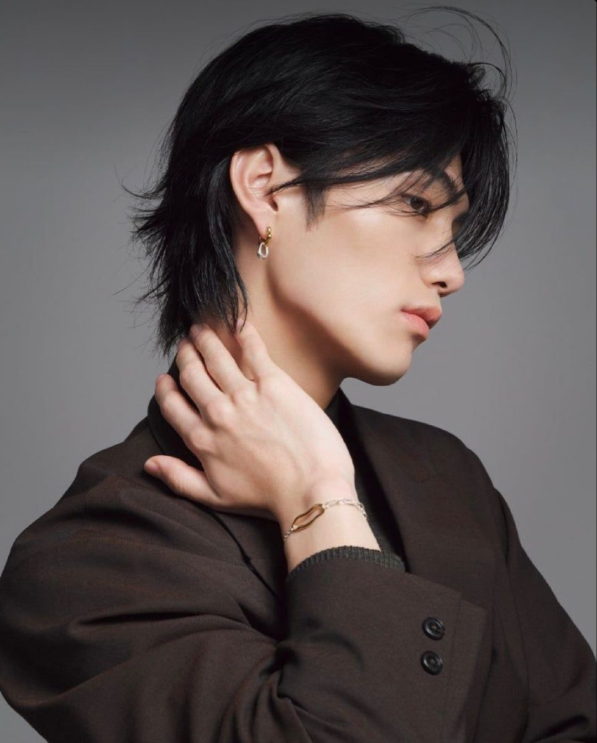 Man with dark hair in black and white